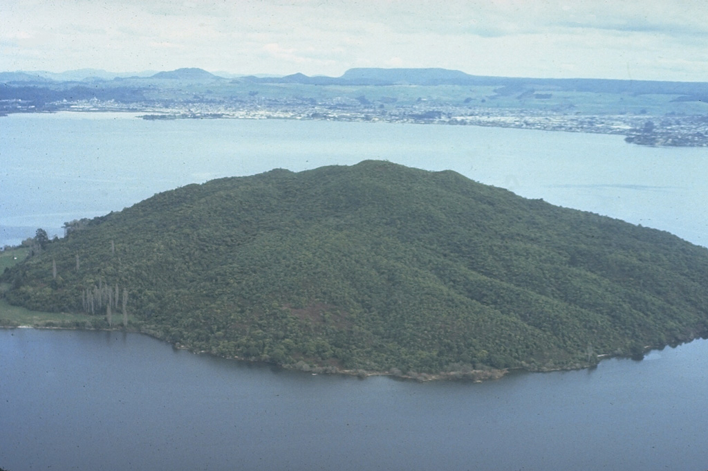 The 17-km-wide Rotorua caldera, largely filled by the waters of Lake Rotorua, was formed during the eruption of the 340 km3 Mamaku Ignimbrite about 220,000 years ago. Eruptive activity ceased during the Pleistocene, but the Mokoia lava dome, forming the island in the foreground, is less than 20,000 years old. Geothermal areas are found around the lake and the city of Rotorua lies across the lake along its southern shore. Photo by Bruce Houghton (Wairakei Research Center).