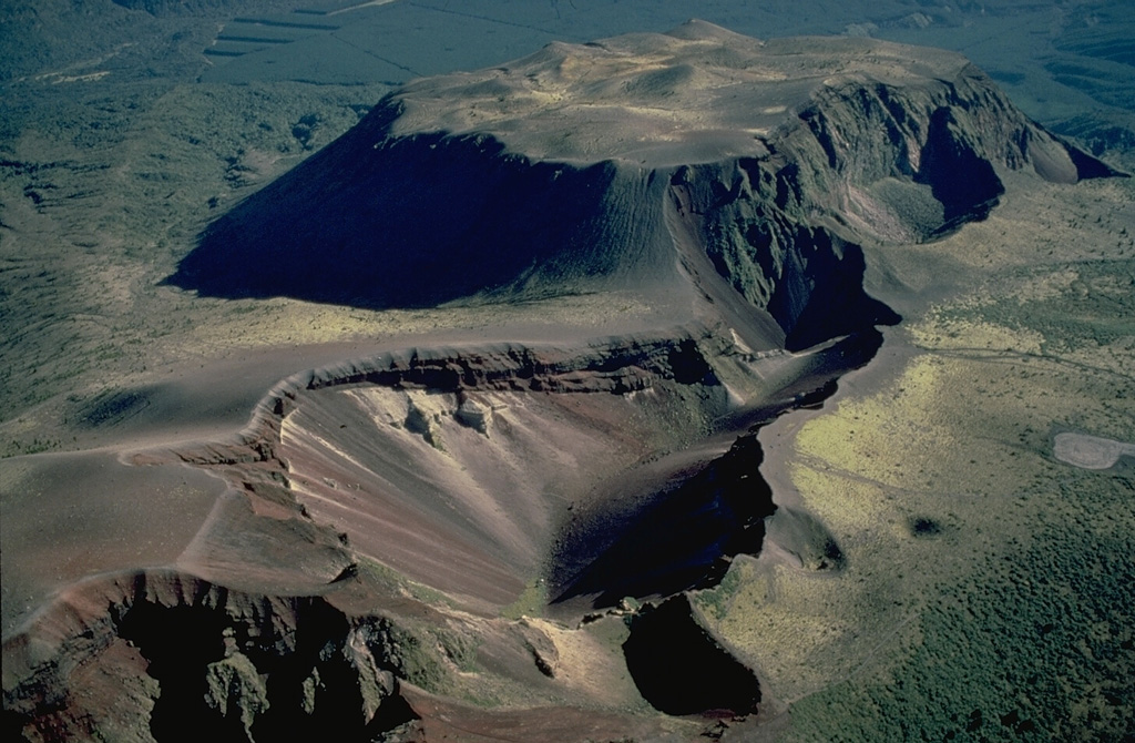 The 1886 eruptive fissure that cuts across the Tarawera lava dome complex was the source of a major explosive eruption that produced 2 cu km of basaltic tephra.  The 1886 fissure cuts a group of lava domes, including the Wahanga dome at the top of the photo, which was emplaced at the end of the Kaharoa eruption about 800 years ago.  That eruption produced 5 cu km of rhyolitic tephra and and another 2.5 cu km of rhyolitoc lava that formed the Wahanga, Tarawera, Crater Dome, and Ruawahia domes. Copyrighted photo by Katia and Maurice Krafft, 1986.