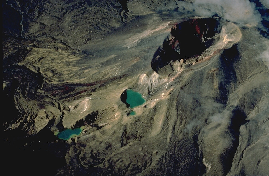 Red Crater (upper right) is one of a dozen or more volcanic centers of the Tongariro volcano group.  The Emerald Lakes, NE of Red Crater, mark a chain of explosion vents associated with eruptions of Red Crater.  Activity at Red Crater continued into historical time.  Minor phreatic explosive eruptions took place during the late 19th century and most recently in 1926. Copyrighted photo by Katia and Maurice Krafft, 1986.