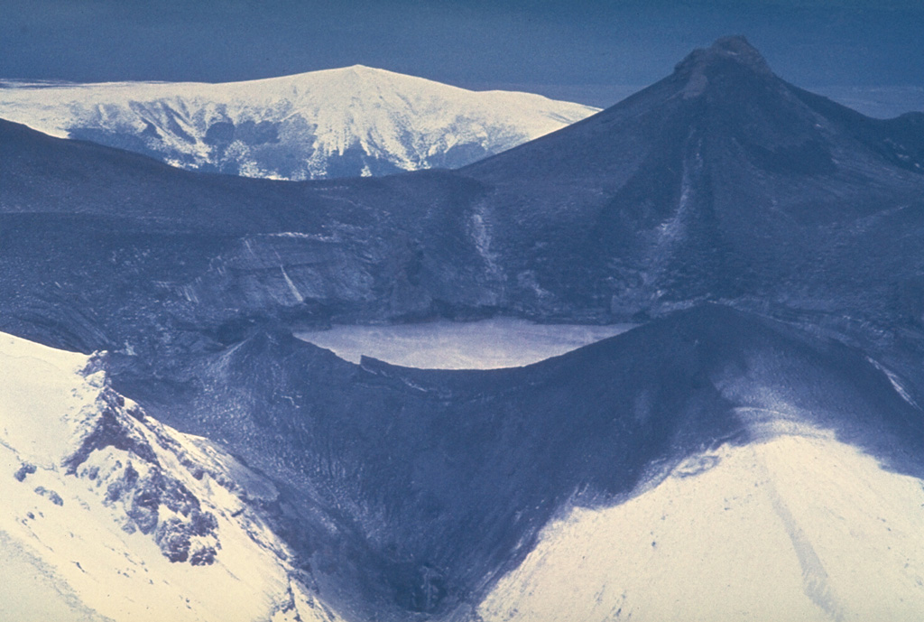 A major phreatomagmatic explosion on 22 June 1969 ejected ash and mud onto the area around Ruapehu's Crater Lake. The hot lake water along with snow melted by pyroclastic surges produced lahars that traveled down the four major valleys below the volcano. At the time, the brief eruption was the largest at Ruapehu since 1945 and lasted two and half hours. Ash-blackened Mitre Peak is at the top right, with the W rim of Crater Lake in the foreground. Photo by Jim Cole, 1969 (University of Canterbury).