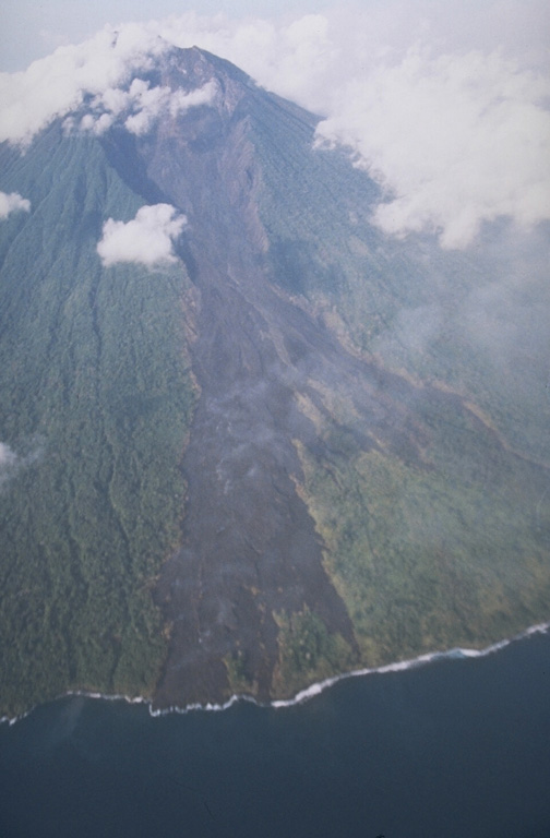 The eruption from Manam that began in 1974 included peaks of activity that produced pyroclastic flows during 1982, 1984, and 1992-94. This December 1992 photo shows a new lava field that was emplaced down the NE valley from August to November 1992. Lava flows from the 1992 eruptions reached the sea on the NE coast and destroyed a village. Photo by Wally Johnson, 1992 (Australia Bureau of Mineral Resources).