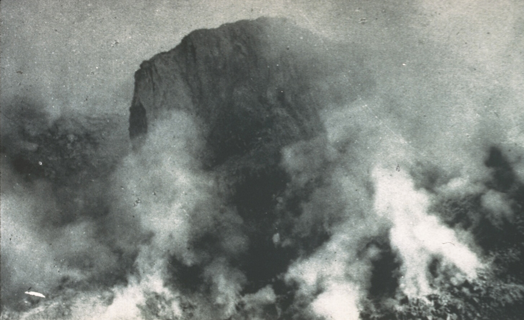 On 19 August 1951 this large lava spine towered about 130 m above the surface of the growing lava dome. Growth of the spine had ceased at about this time. Extrusion and destruction of lava spines occurred frequently during the five-year long period of lava dome growth. Photo by Tony Taylor, 1951 (Australia Bureau of Mineral Resources).