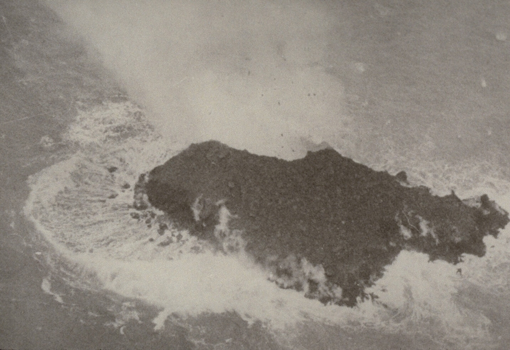 A newly-formed island at Kavachi on 9 September 1976. Submarine explosions ejected fountains of water and rock about 60 m high on 24 August. Similar activity was observed 4-6 September. By the 7th, lava effusion was observed. Lava flows ceased between 9-11 September, but explosions continued, and by the 15th the island was 100 m long. By 6 October the island was eroded. Explosive eruptions were last observed on 13 October from a vent estimated to be less than 15 m below sea level. Photo by Deni Tuni, 1976 (Ministry of Lands, Energy and Mineral Resources, Solomon Islands).