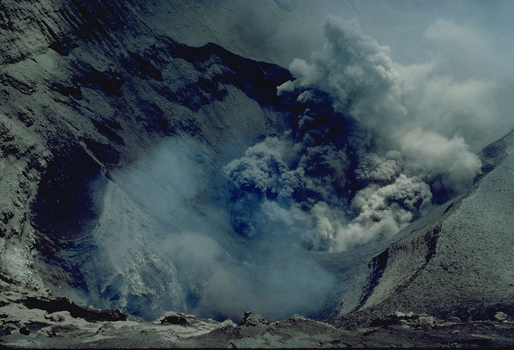 An ash column is ejected from one of several vents on the floor of the summit crater of Yasur volcano in 1982.  The frequent eruptions of this volcano have drawn visitors to Tanna Island. Copyrighted photo by André Demaison, 1982 (courtesy of Katia and Maurice Krafft).