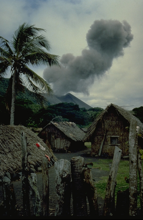 An ash cloud rising above the summit crater of Yasur volcano is seen from a village on Tanna Island in 1982.  Yasur, the best-known and most frequently visited of the Vanuatu volcanoes, has been in more-or-less continuous strombolian activity since Captain Cook observed ash eruptions in 1774. Copyrighted photo by André Demaison, 1982 (courtesy of Katia and Maurice Krafft).