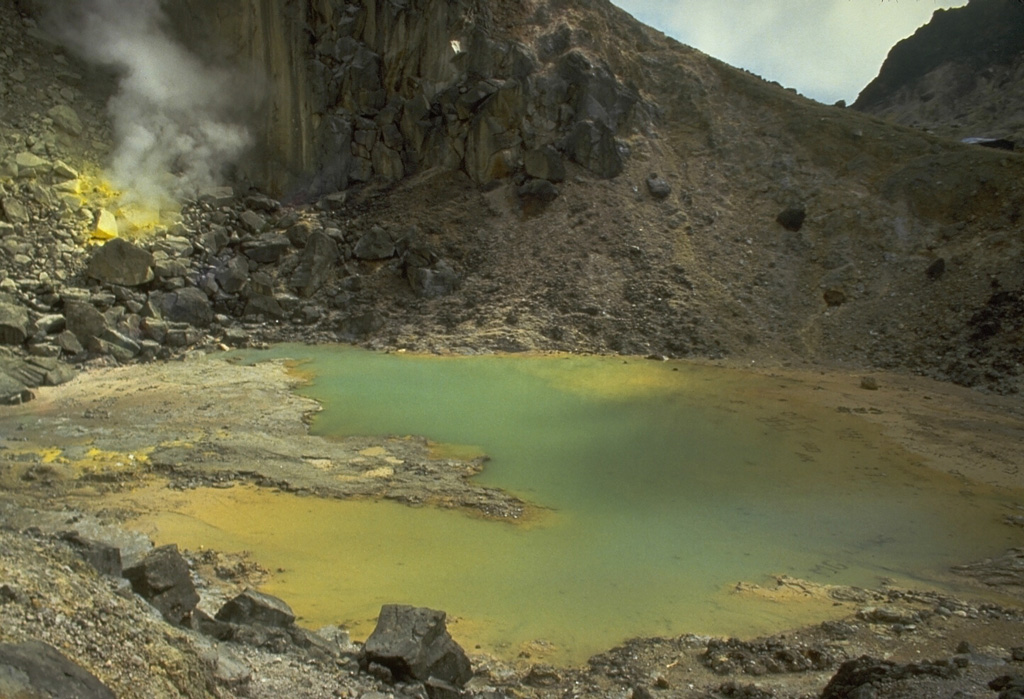 A small crater lake near the summit of Sibayak volcano shows active fumaroles and sulfur mineralization. An active fumarole is visible at the upper left. The lake is popular destination for weekend climbers from villages and towns surrounding the volcano. Photo by Tom Casadevall, 1987 (U.S. Geological Survey).