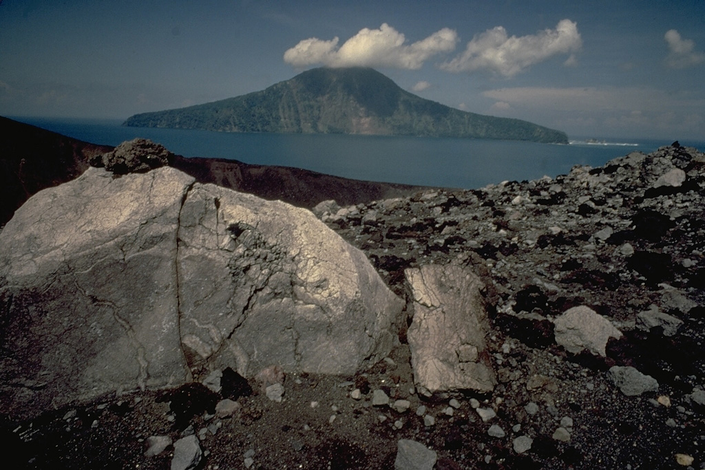 Large blocks litter the rim of the crater of Anak Krakatau in the center of Krakatau caldera.  The truncated face of Rakata Island in the background 4 km to the south is part of the south rim of  the caldera. Copyrighted photo by Katia and Maurice Krafft, 1971.