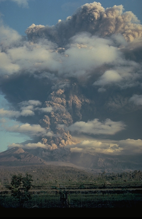 A powerful eruption column rises above the breached crater of Galunggung volcano in September 1982, in this view from the SE.  Intermittent explosive eruptions had taken place since the start of the eruption on 5 April, accompanied by pyroclastic flows and lahars that caused much devastation.  More than 40,000 people were evacuated during the eruption. Copyrighted photo by Katia and Maurice Krafft, 1982.