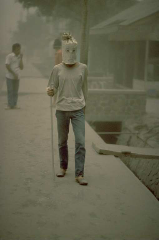 Ash-laden air during the 1982 eruptions of Galunggung volcano created respiratory problems for residents, who used materials at hand to make breathing easier.  Ash originated both directly from the volcano and from redistribution of previously fallen ash by winds and vehicle traffic. Copyrighted photo by Katia and Maurice Krafft, 1982.