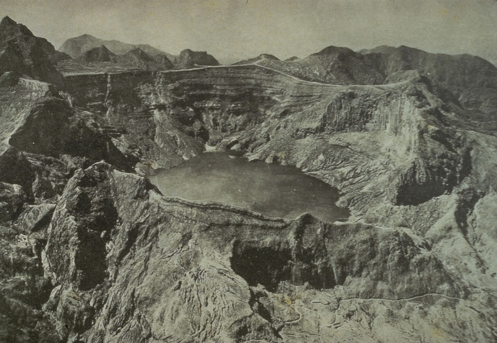 This August 1922 photo from the NW shows the still vegetation-free summit of Kelud volcano following the powerful May 1919 eruption and the relatively mild December 1920 eruption. The 1919 eruption produced devastating pyroclastic flows and lahars that killed over 5,110 people. This prompted an engineering project to construct tunnels to lower the level of the crater lake, which was completed in 1926. A milder explosive eruption in 1920 was accompanied by extrusion of a small lava dome beneath the crater lake.  Photo published in Taverne, 1926 