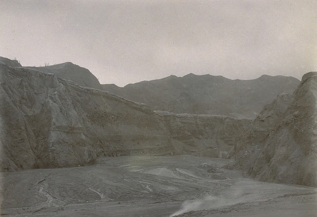 The upper flanks of Kelud volcano were swept by pyroclastic flows during the 1919 eruption.  The brief eruption the night of August 19-20 produced pyroclastic flows and devastating lahars that totally destroyed 104 villages and killed 5110 people.  This view of the upper Sumber Petung valley shows the completely devegetated upper slopes of the volcano. Photo from the collection of Maurice and Katia Krafft.