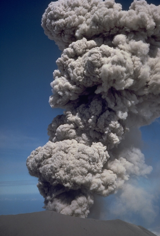 An explosive eruption at the summit crater of Semeru on 17 August 1985. This activity is typical of Semeru, which has been in near-continuous eruptive activity since 1818, producing frequent small-to-moderate explosions that eject ash and volcanic bombs. Some larger eruptions have produced pyroclastic flows and lahars that have reached the foot of the volcano. Photo by Tom Casadevall, 1985 (U.S. Geological Survey).