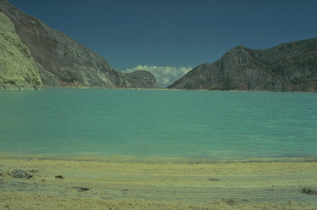 Kawah Ijen, at the eastern tip of Java, contains a 1-km-wide turquoise-colored crater lake with sulfur-stained walls.  Strand lines of sulfur can be seen along the shores of the lake, where elemental sulfur is mined.  Small phreatic eruptions have taken place from the lake in historical time. Copyrighted photo by Katia and Maurice Krafft, 1976.