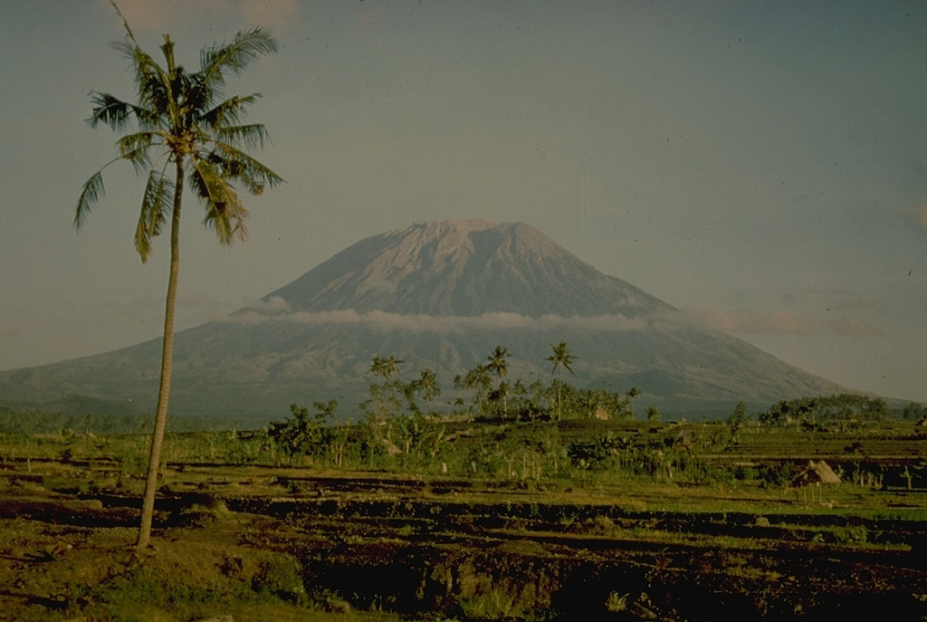 Agung volcano towers over the eastern end of the island of Bali.  A steep-walled, 200-m deep crater is located at the summit of the 3142-m-high volcano.  Only three eruptions have been recorded in historical time; the latest, in 1963-64, produced devastating pyroclastic flows and lahars. Copyrighted photo by Katia and Maurice Krafft, 1971.