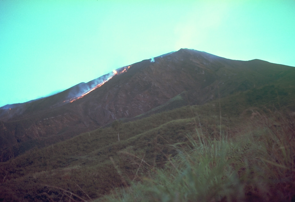 A lava flow descends the W flank of Doro Api at Sangeang Api volcano on 4 December 1985. The eruption began on 30 July and pyroclastic flows forced the evacuation of the island's 1,242 inhabitants. The lava flow eventually traveled 4-5 km before stopping in June 1986. Explosive activity continued until February 1988. Photo by Tom Casadevall, 1985 (U.S. Geological Survey).