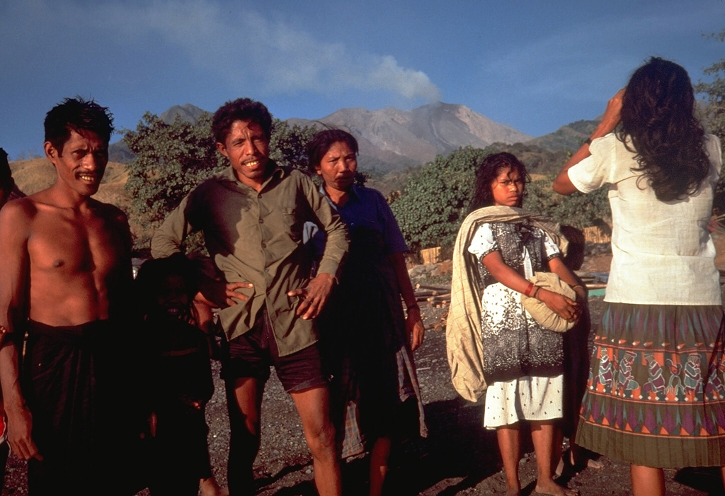 Islanders prepare to evacuate on 25 August 1985 as Sangeang Api volcano erupts in the background. The eruption began on 30 July and produced pyroclastic flows that eventually forced the evacuation of the island's entire 1,242 inhabitants. Photo by Tom Casadevall, 1985 (U.S. Geological Survey).