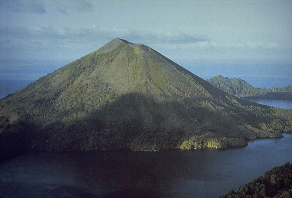 Banda Api volcano is seen here from the SW prior to a major eruption in 1988.  The ridge in the right background is Neira Island; at the bottom right is the western tip of Lonthur Island.  Both islands are remnants of calderas inside which the conical Gunung Api stratovolcano was constructed.  One of many peaks named Gunung Api ("Fire Mountain") in Indonesia, Banda Api is the most active volcano of the Banda arc. Photo courtesy Tom Casadevall (U.S. Geological Survey).