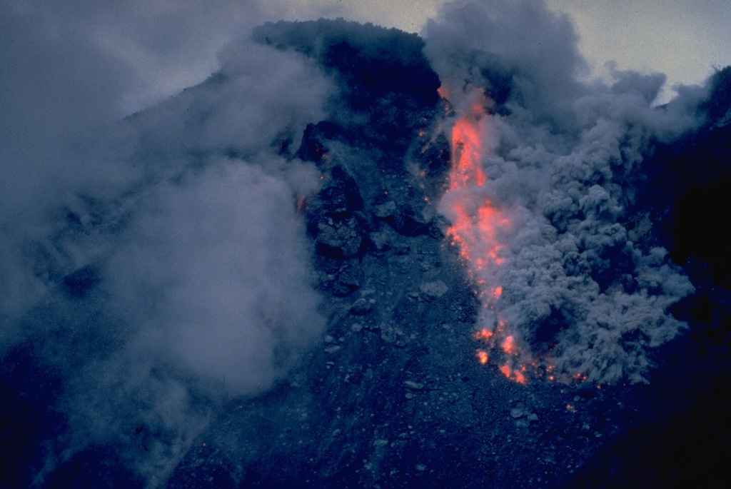 Ash clouds rise above incandescent rockfall from collapse of a growing lava dome on February 15, 1988.  Anak Ranakah dome began forming on December 28, 1987, in an area without previous historical activity.  Dome growth continued into 1989. Copyrighted photo by Katia and Maurice Krafft, 1988.