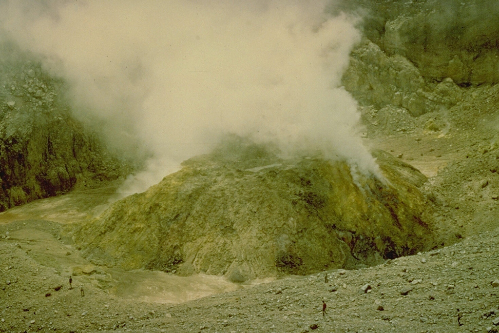 A sulfur-encrusted, steaming lava dome in the summit crater of Lewotobi Perempuan volcano (seen here in 1971) was formed during an eruption from January 1 to December 1921.  The only other historical eruption of Lewotobi Perampuan was in 1935, although its twin volcano to the SE, Lewotobi Lakilaki, is one of the most active volcanoes on Flores Island, with frequent eruptions in the 19th and 20th centuries. Copyrighted photo by Katia and Maurice Krafft, 1971.