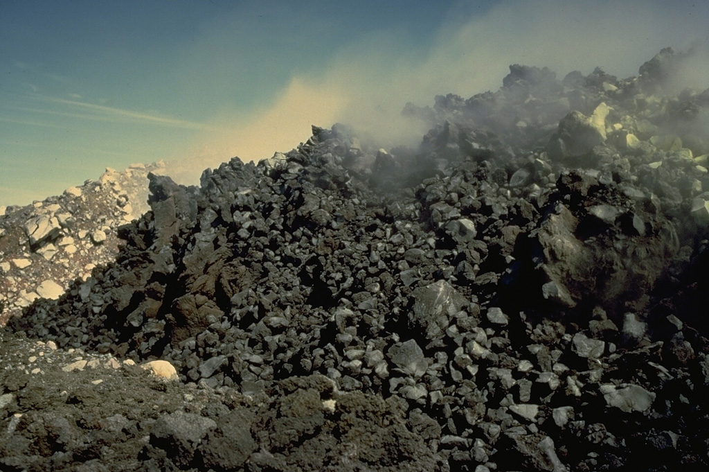 A lava dome, seen here in November 1971, was emplaced in the summit crater at end of an eruption that lasted from November 1970 to March 1971.  Emplacement of the dome was accompanied by pyroclastic avalanches down the west flank.  The eruption included explosive activity and emission of a lava flow down the east flank. Copyrighted photo by Katia and Maurice Krafft, 1971.