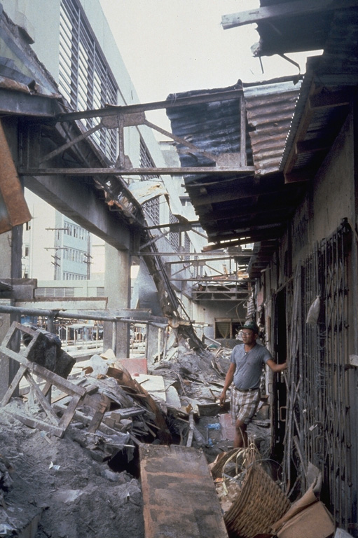 Heavy ashfall from the 15 June 1991 eruption of Pinatubo caused collapse of the roof of this public market in Olapango City near Subic Bay Naval Air Station. About 10-15 cm of ash fell at this location, 35 km S of the volcano. Photo by Tom Casadevall, 1991 (U.S. Geological Survey).