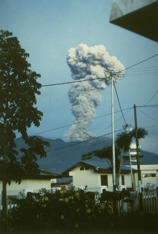 An ash-rich eruption column rises above a town at the western foot of Sumatra's Marapi volcano on 10 May 1992. The activity was part of an ongoing eruption that began in January 1987 from Verbeek crater. The explosions frequently produced light ashfall in surrounding areas, but did not cause damage. The eruption included growth of a lava dome in the summit crater. Photo by Gede Suantika, 1992 (Volcanological Survey of Indonesia).