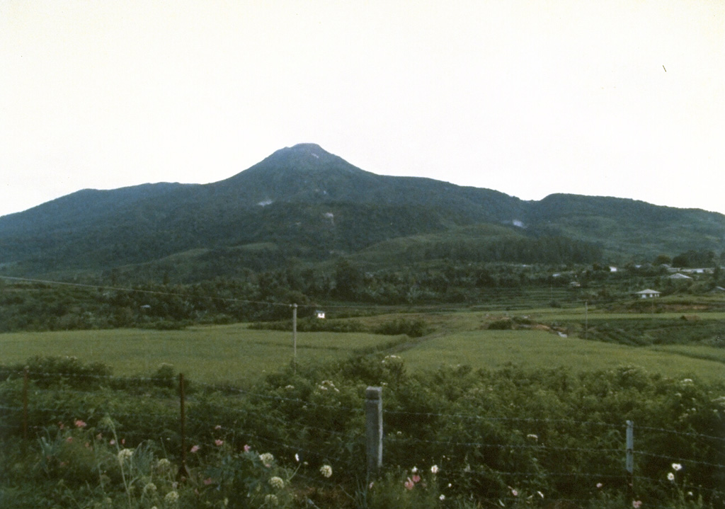 Talang volcano, seen here from the Volcanological Survey of Indonesia observation post at Batu Barjangan on the NNE side, is located next to the older Pasar Arbaa volcano. Historical eruptions have originated from a valley on the NE flank and have consisted of mild explosive activity. Photo by Ruska Hadian, 1986 (Volcanological Survey of Indonesia).