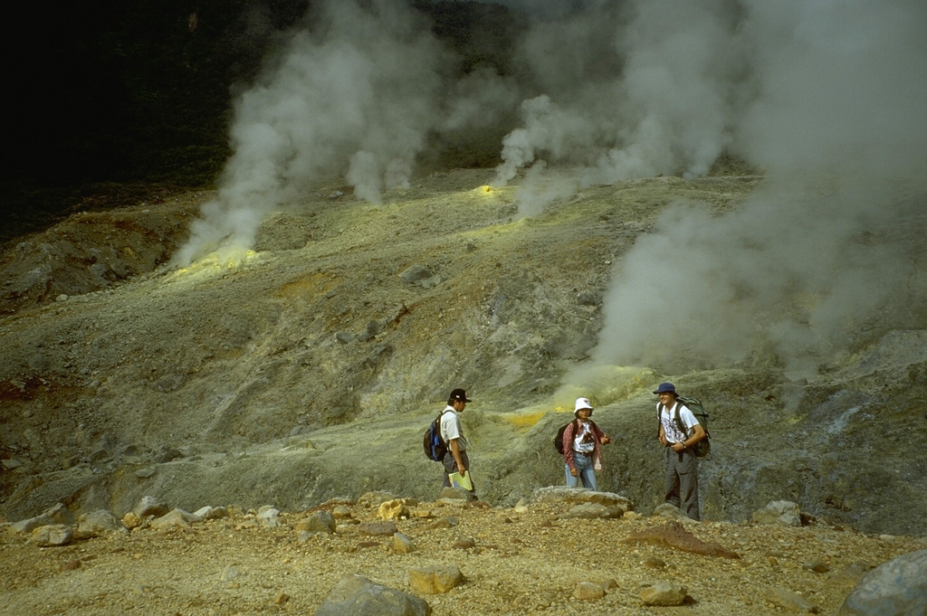 The active Kawah Mas crater contains numerous high-temperature fumarolic vents, many surrounded by deposits of sulfur. The fumarole temperatures are monitored by scientists from the Volcanological Survey of Indonesia. Phreatic explosions have occurred during historical time from vents near Kawah Mas. Photo by Lee Siebert, 1995 (Smithsonian Institution).