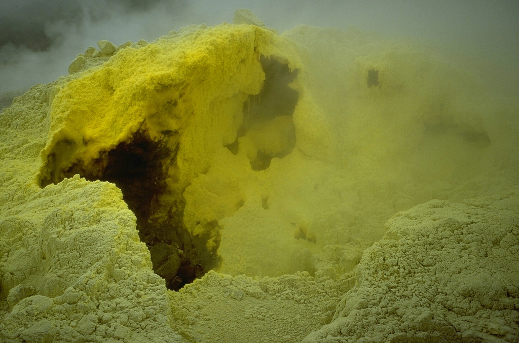 Volcanic gas emissions from a sulfur-encrusted fumarole at Kawah Mas ("Golden Crater") at Papandayan. The crater contains a large number of high-temperature fumaroles with temperatures of several hundred degrees Celsius. Photo by Lee Siebert, 1995 (Smithsonian Institution).