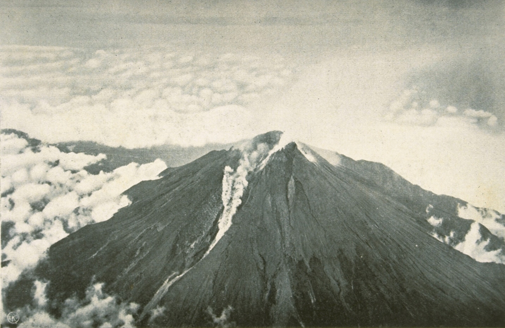 A small pyroclastic flow is shown traveling down the western flank from the breached crater of Merapi volcano in December 1930. A much larger pyroclastic flow that month traveled 12 km from the volcano, totally or partially destroying 42 villages and killing 1,369 people in one of Merapi's deadliest eruptions. Explosions had begun on 22 November 1930, accompanied by growth of a new lava dome and extrusion of a lava flow. Dome growth and associated pyroclastic flows (block-and-ash flows) continued until October 1931. Photo published in Neumann van Padang, 1933 (courtesy of Volcanological Survey of Indonesia).