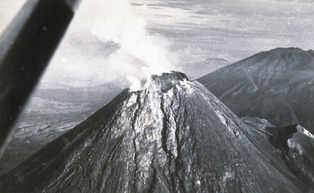 The degassing, growing lava dome of Merapi volcano on 20 January 1954, as viewed from the SE, two days after a major pyroclastic flow that caused 64 fatalities. Lava dome growth had begun on 2 March 1953, accompanied by frequent pyroclastic flows (block-and-ash flows). Several additional cycles of lava dome growth and destruction continued until December 1958. Photo by Suryo, 1954 (Volcanological Survey of Indonesia).
