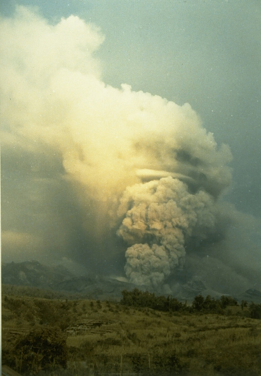 An ash plume rises above a pyroclastic flow descending a west side valley of Kelud volcano in February 1990. During the 10 to 16-17 February eruption pyroclastic flows traveled 7-8 km from the volcano and lahars destroyed nearby agricultural land. Photo by Ruska Hadian, 1990 (Volcanological Survey of Indonesia).