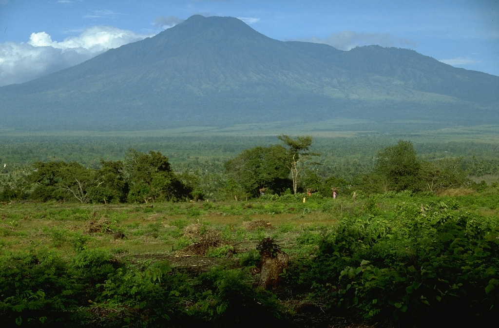 Gunung Merapi, less known than the renowned Merapi volcano of central Java, is located on the E rim of the 20-km-wide Ijen caldera in easternmost Java. The crater lake of Kawah Ijen is located behind the right-hand skyline of this view from the NW. Photo by Lee Siebert, 1995 (Smithsonian Institution).