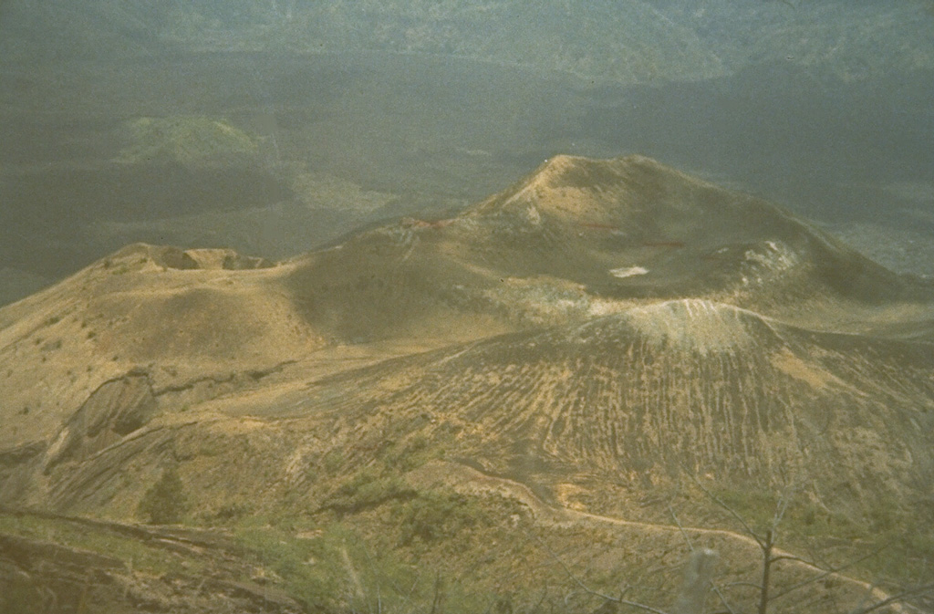 This is the Batur I summit crater of Batur volcano, a cone constructed within the 7.5-km-wide Batur caldera. A chain of cones and craters was constructed along a NE-SW-trending line across the summit. Historical eruptions have occurred from Batur I, Batur II, Batur III, and other flank cones. Photo by Sumarma Hamidi, 1973 (Volcanological Survey of Indonesia).