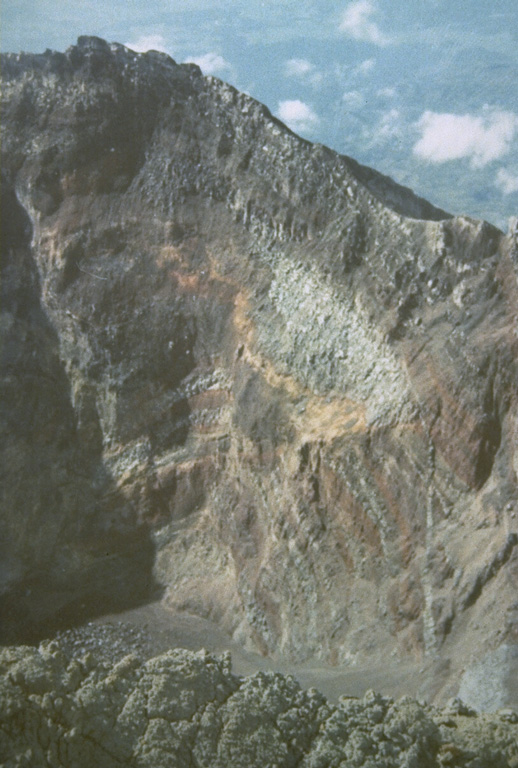 The summit of Bali's Gunung Agung contains a 500-m-wide, 200-m-deep crater that is the source of the historical eruptions. Gray lava flows and brown tephra layers from explosive eruptions are exposed in the crater wall. Photo by Sumarna Hamidi, 1973 (Volcanological Survey of Indonesia).