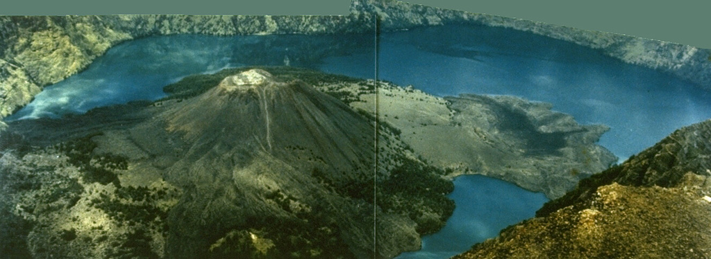 The Barujari pyroclastic cone, the most prominent post-caldera feature at Rinjani volcano, was formed at the eastern end of the oval-shaped Segara Anak caldera. This 1993 view from the NE caldera rim shows a peninsula on the right formed by lava flows from a NW vent that entered the caldera lake in 1944 as well as lava flows on the left side of Barujari that flowed N and S into the lake during a 1966 eruption. Photo courtesy Volcanological Survey of Indonesia, 1993.