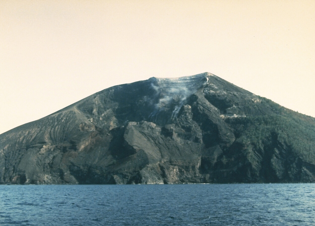The southern side of the small Iya volcano in central Flores with a weak plume rising from a crater near the summit. Gunung Iya is the southernmost of three volcanoes forming a small peninsula south of Ende. Photo by Ruska Hadian, 1985 (Volcanological Survey of Indonesia).