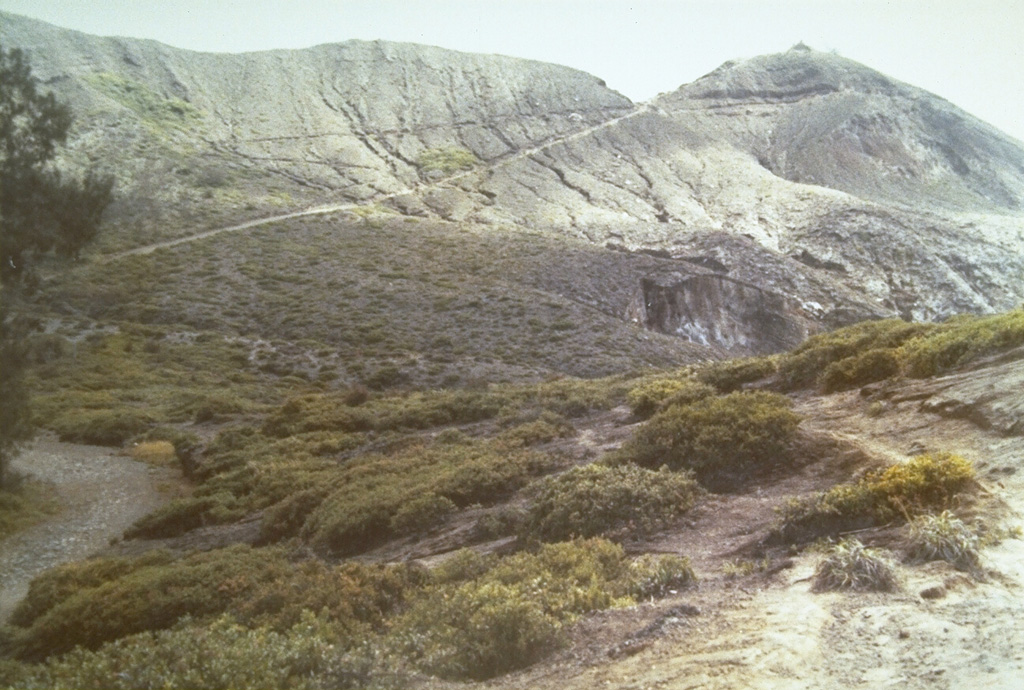 The summit of Kelimutu volcano is elongated 2-3 km in a WNW-ESE direction and contains three crater lakes. A trail ascending the eastern wall of the NW-most cone leads to Tiwu Ata Mbupu crater lake. Photo by L.D. Reksowirogo, 1972 (Volcanological Survey of Indonesia).