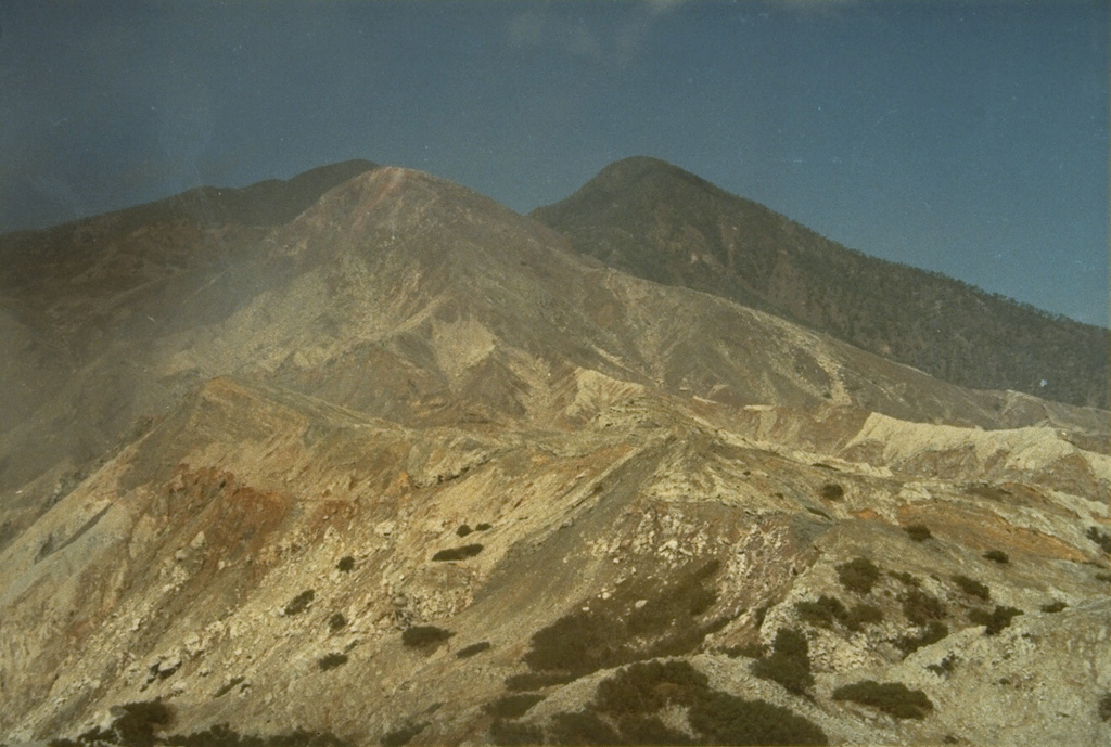 Sirung volcano, seen here from the north, lies at the NE end of a 14-km-long line of volcanic centers forming a peninsula at the southern end of Pantar Island.  A  2-km-wide caldera at the summit has been the source of small phreatic eruptions during the 20th century.  A lava dome (right) forms the 862-m-high summit of the volcano at the west side of the caldera. Photo by L.D. Reksowirogo, 1972 (Volcanological Survey of Indonesia).