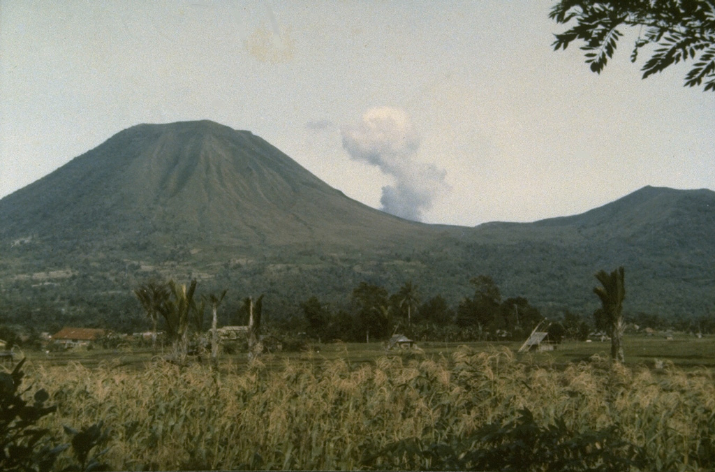 The twin volcanoes Lokon (on the left) and Empung (on the right) rise above Tondano Plain.  Steam rises from Tompaluan, a double crater between the two peaks.  The higher peak, 1580-m-high Lokon, has a flat, craterless summit, whereas Empung, which was active prior to 1800, has a 400-m-wide summit crater.  All eruptions of Lokon-Empung since 1826 have originated from Tompaluan crater between the two peaks. Photo by Ruska Hadian, 1986 (Volcanological Survey of Indonesia).