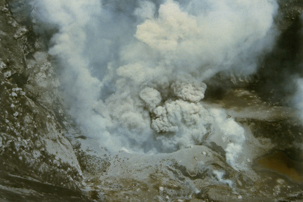 A small ash eruption from a vent at the bottom of Tompaluan crater on Lokon-Empung volcano is seen from the crater rim on July 20, 1986.  The eruption, which began in March, lasted until May of the following year. Photo by Ruska Hadian, 1986 (Volcanological Survey of Indonesia).