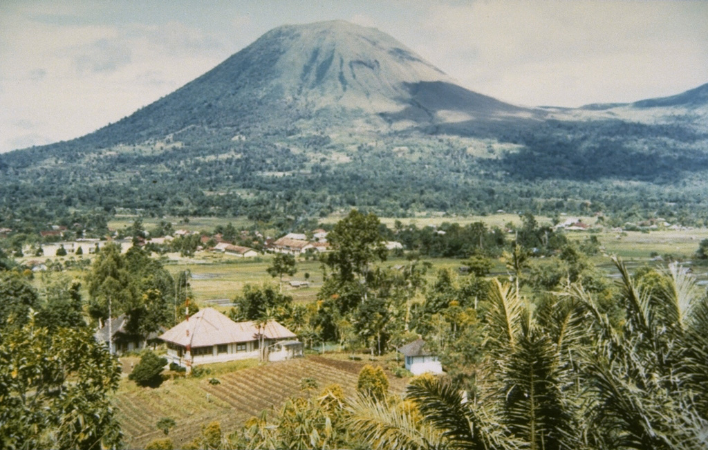 The twin volcanoes Lokon and Empung rise 800 m above the plain of Tondano.  The more prominent Lokon volcano, seen here from the Kakaskasen Volcano Observatory on the SE, is higher than Empung volcano, part of which is visible at the right.  Most historical eruptions from Lokon-Empung, one of the most active volcanoes on Sulawesi Island, have originated from Tompaluan crater, located at the right in the saddle between the two peaks. Photo by S.R. Wittiri, 1990 (Volcanological Survey of Indonesia).