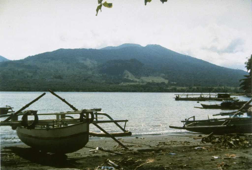 Tongkoko volcano, seen here from Lembe Island to the east, is a broad, 1149-m-high stratovolcano capped by a large summit crater.  The lava dome Batu Angus, which formed in an eruption in 1801, can be seen on the east flank of the volcano in the center of the photo.  Gunung Dua Saudara National Park, a noted wildlife preserve, extends from the volcanic highlands to offshore coral reefs.   Photo by Ruska Hadian (Volcanological Survey of Indonesia).