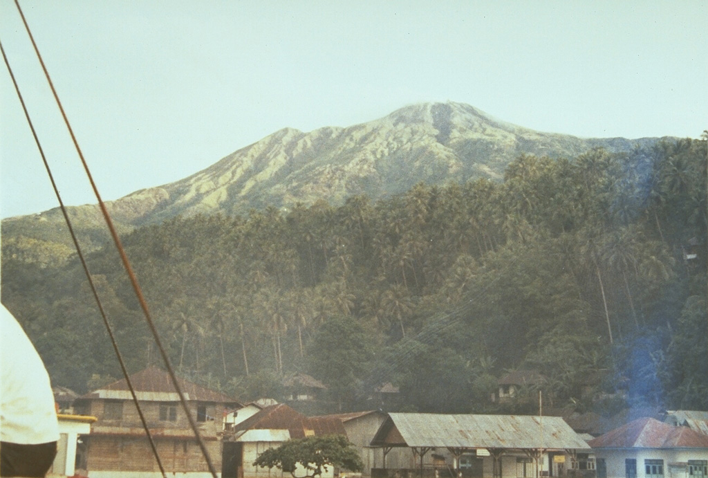 Karangetang volcano, also known as Api Siau, is the northernmost of a chain of volcanoes forming the elongated island of Siau in the Sangihe arc.  Seen here from Ulu village on the north, Karangetang is one of Indonesia's most active volcanoes, with more than 40 eruptions recorded since 1675. Photo by Ruska Hadian, 1973 (Volcanological Survey of Indonesia).