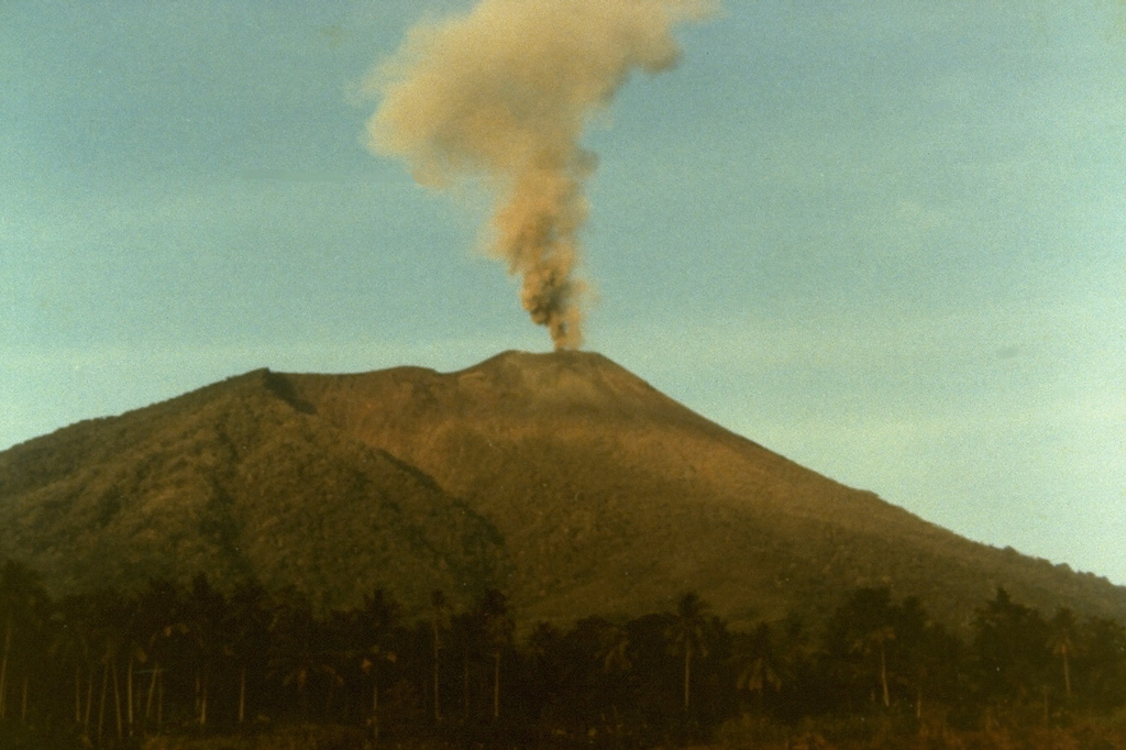 A small explosive eruption of Gamalama volcano in September 1980 is seen from the airport on the NE side of Ternate Island.  Nearly 40,000 people evacuated to a nearby island during the first two days of the eruption, which began on 4 September and lasted until the 23rd. Photo by S.R. Wittiri, 1980 (Volcanological Survey of Indonesia).