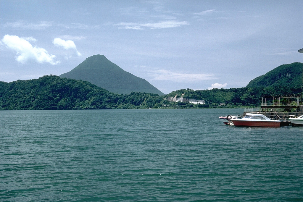 Ikedako is a 4.5-km-wide lake-filled caldera that was formed as a result of a major explosive eruption about 4,600 years ago. Kaimon is the highest peak of the Ibusuki volcanic field, rising to the SW above the caldera rim. The eruption of the 3 km3 Ikeda pumice was the the largest Holocene eruption in the Ibusuki volcanic field, which consists of a group of small central volcanoes and maars, along with Ikedako caldera and Kaimon. Photo by Lee Siebert, 1988 (Smithsonian Institution).