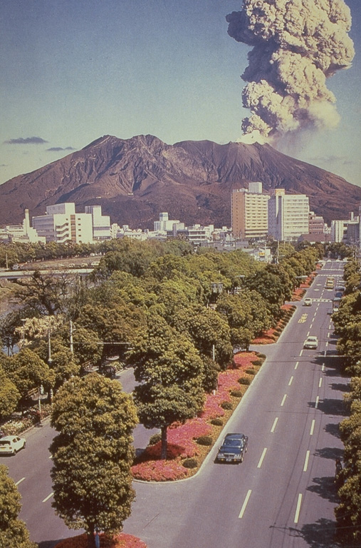 An eruption plume from Sakurajima, one of Japan's most active volcanoes, rises above the city of Kagoshima. It is a post-caldera volcano of the Aira caldera at the northern half of Kagoshima Bay. Eruptions began around 13,000 years ago and built an island that joined the Osumi Peninsula during the eruption of 1914. Frequent eruptions have been recorded since the 8th century. Photo courtesy of Richard Fiske (Smithsonian Institution).