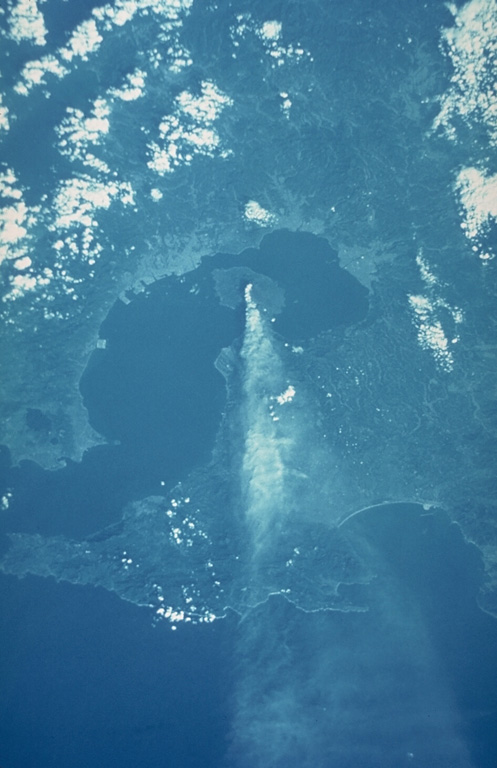 A space shuttle photograph taken on 6 October 1985 shows an ash plume dispersing E from Sakurajima across the Osumi Peninsula to the Pacific Ocean. Sakurajima is near the S rim of the 20-km-wide Aira caldera that encompasses much of the N end of Kagoshima Bay. The caldera formed during an eruption about 22,000 years ago. Kagoshima City is the lighter-colored area across the bay immediately W. NASA Space shuttle image, 1985 (http://eol.jsc.nasa.gov/).
