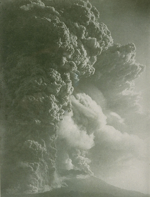 The 1914 eruption, one of the largest in historical time from Sakura-jima, began with powerful explosions on January 12 from a vent on the west flank, and ten minutes later on the east flank. The initial plinian phase, seen here from Kagoshima City to the west, lasted until the next day, when lava emission began.  Lava flows extended the shoreline on the west and east sides, eventually joining Sakura-jima island to the Osumi Peninsula.  Damage to croplands and houses on the island from the 1914 eruption was severe. From the collection of Maurice and Katia Krafft.
