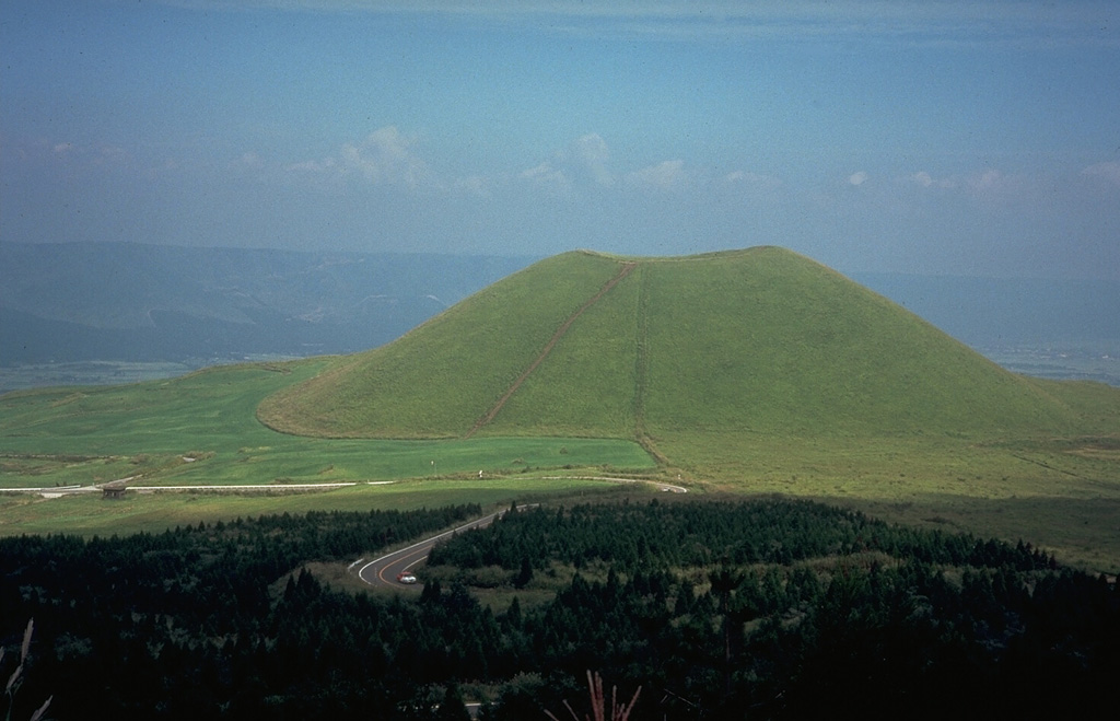Kometsuka scoria cone, on the NW side of the central cone complex of Aso volcano on the island of Kyushu, was constructed about 1,800 years ago. The cone formed during explosive eruptions that were accompanied by lava flows. The Aso caldera walls are visible in the distance. Photo by Dick Stoiber, 1981 (Dartmouth College).